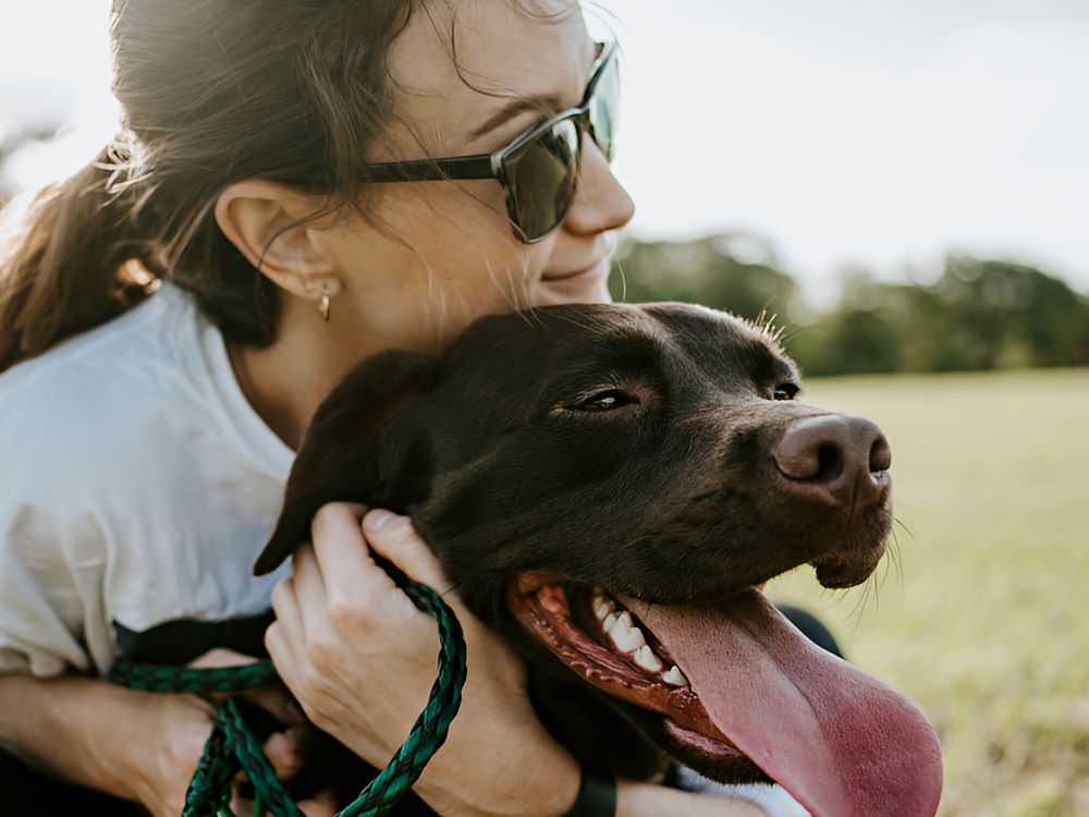 Woman hugging her dog